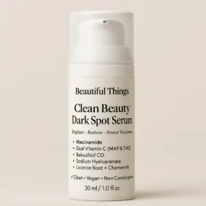 A 30ml white airless pump bottle labeled “Beautiful Things Clean Beauty Dark Spot Serum” with minimalist design, showcasing key ingredients like Niacinamide, Vitamin C, Bakuchiol, and Chamomile, photographed against a soft beige background
